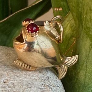 Sold.    18 karat gold, vintage, puffy fish charm